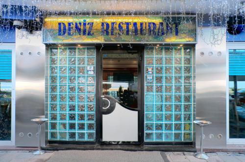 a store front with a door with a sign on it at Izmir Palas Hotel in İzmir
