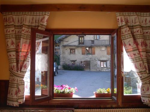 an open window with a view of a building at Le Dôme in Tignes