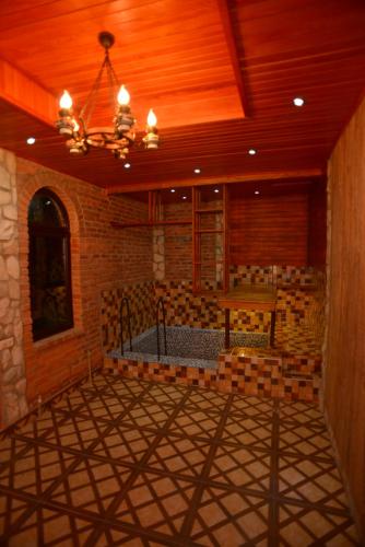 a large room with a wooden ceiling and a chandelier at Chateau Chikovani in Gordi
