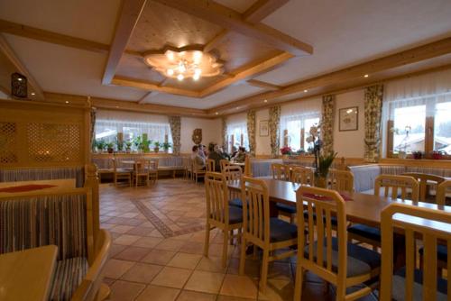 a dining room with tables and chairs in a restaurant at Ferienhaus Grubhof in Saalbach Hinterglemm