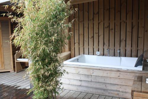 a white bath tub sitting on a wooden deck at Hotel Krone Sihlbrugg in Sihlbrugg Dorf