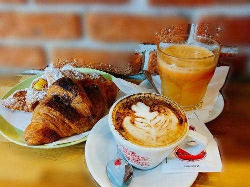 a table with a cup of coffee and a plate of pastries at Camping Venezia Village in Mestre