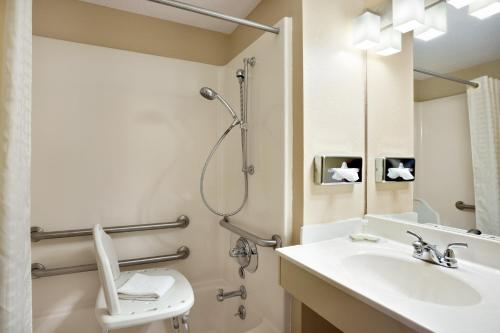 a bathroom with a sink and a toilet and a mirror at Super 8 by Wyndham Mount Vernon, IL in Mount Vernon