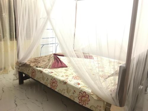 a bed in a room with a window at Mount nature villa in Hikkaduwa