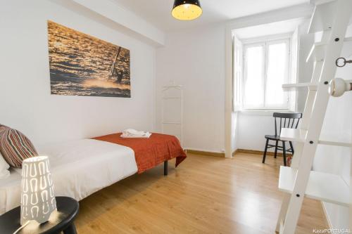 a white bedroom with a bed and a desk at Casa Sanches in Cascais