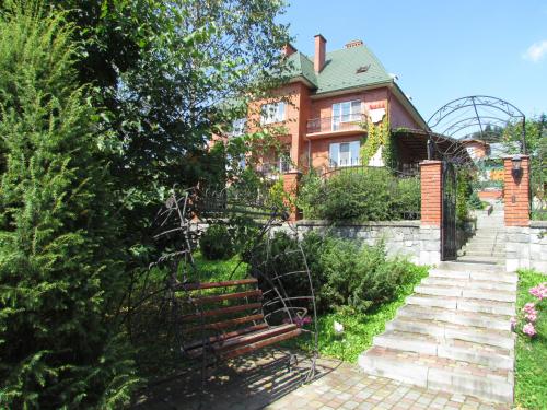 a house with a bench in front of it at Zolotoie Runo in Skhidnitsa
