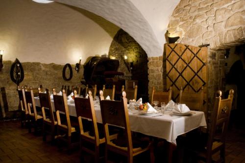 a dining room with a white table and chairs at Hotel Zámeček Pod Hradem Starý Jičín 111 in Starý Jičín