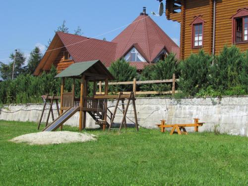 a playground in a yard in front of a house at Zolotoie Runo in Skhidnitsa