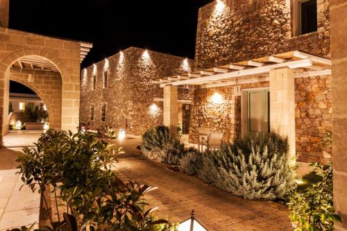 a stone building with lights on it at night at Montiro' Hotel in Leuca