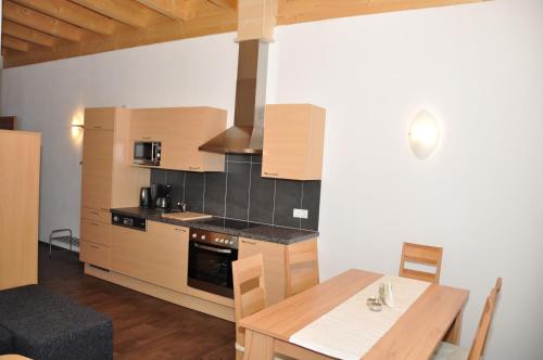 a kitchen with a stove and a table with a dining room at Appartements Montana in Vent