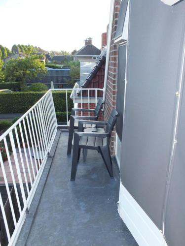a bench on the balcony of a house at B&B Ferdivedaasje in Dokkum