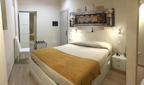 a small bedroom with a bed and a chair at Il Principe in Ravanusa