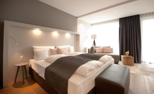 a bedroom with a large bed and a large window at Hotel Restaurant zur Marienburg in Pünderich