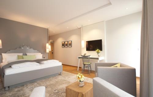 a bedroom with a bed and a living room at Hotel Restaurant zur Marienburg in Pünderich