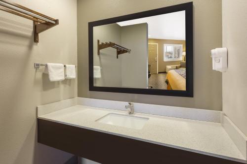 a bathroom with a sink and a mirror at Super 8 by Wyndham Fortuna in Fortuna