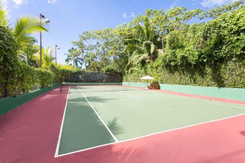 a tennis court in front of a wall at Apartment in Sublime Samana Résidence in Las Terrenas