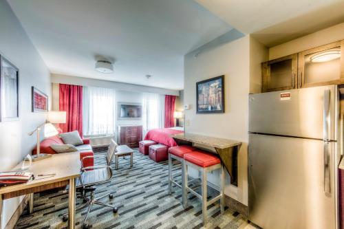 a kitchen and living room with a refrigerator at Staybridge Suites - University Area OSU by IHG in Columbus