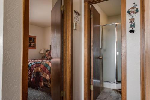 a hallway leading to a bedroom with a bed at Franciscan Lodge in Tahoe Vista