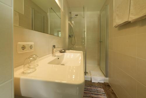 a white bathroom with a sink and a shower at Fleckhof in Neustift im Stubaital