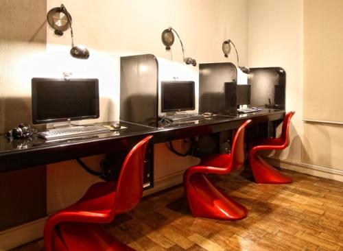 a desk with red chairs and a computer on it at Club Punta Fuego in Nasugbu