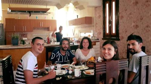 a group of people sitting at a table eating at Villamar Sea View in Hurghada