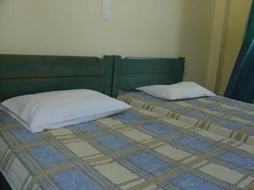 a bed with two pillows on top of it at Bali Studios - Marinakis in Balíon