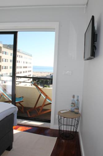 a living room with a view of a balcony at Sea & Fish apartments in Matosinhos