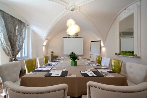 a large conference room with a long table and chairs at Le Castellas Hotel & SPA - TERITORIA in Collias