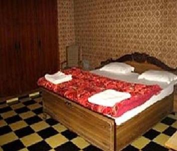 a bedroom with a bed with towels on it at Sai Palace in Agra