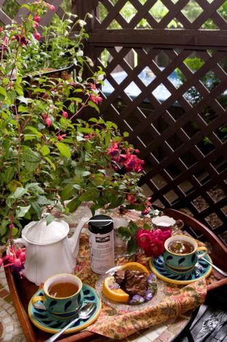 a table with two cups of coffee and plates of food at Creekwalk Inn Bed and Breakfast with Cabins in Cosby