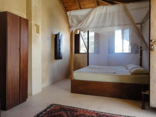 a bedroom with a bed with a canopy at Subira House in Lamu