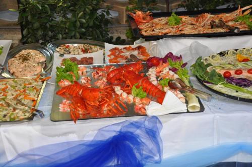 a table with many plates of food on it at Hotel Gioiella Depandance in Bellaria-Igea Marina