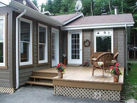 a house with a wooden deck with a chair on it at Bed and Breakfast Du Repos in Saint Quentin