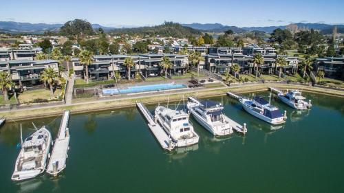 a group of boats are docked in a marina at Sovereign Pier On The Waterways in Whitianga