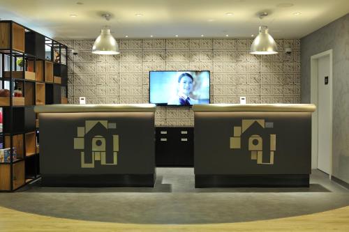 a bar with a tv in a room at Campanile Shanghai Natural History Museum Hotel in Shanghai