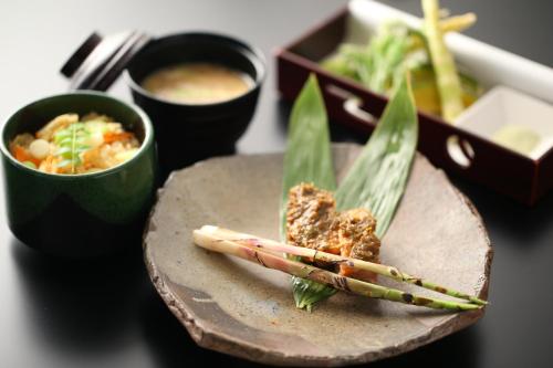 a plate of food with chopsticks on a table at Hotel Japan Shiga in Yamanouchi