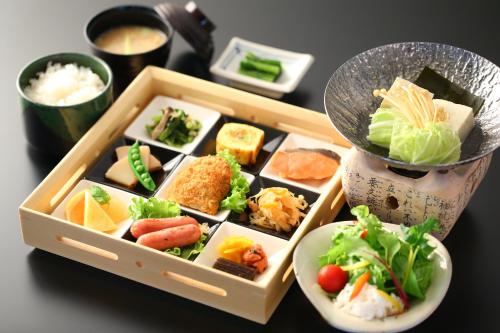 a tray of food on a table with sushi at Hotel Japan Shiga in Yamanouchi