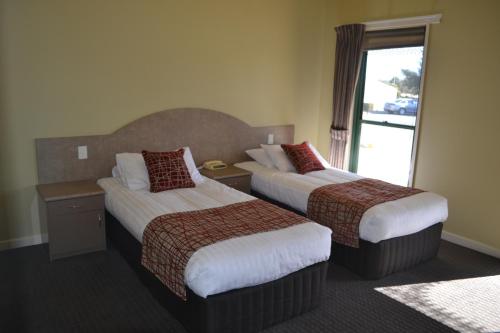 a hotel room with two beds and two lamps at Yarrawonga Mulwala Golf Club in Yarrawonga