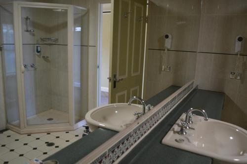 a bathroom with two sinks and a bathtub at Yarrawonga Mulwala Golf Club in Yarrawonga