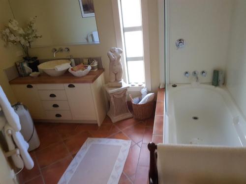 a bathroom with a tub and a sink at The Glen Taupo in Taupo