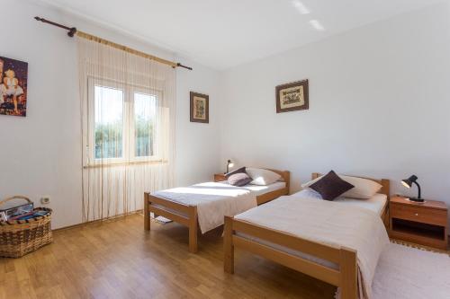 a bedroom with two beds and a window at Casa Istriana Pula in Pula