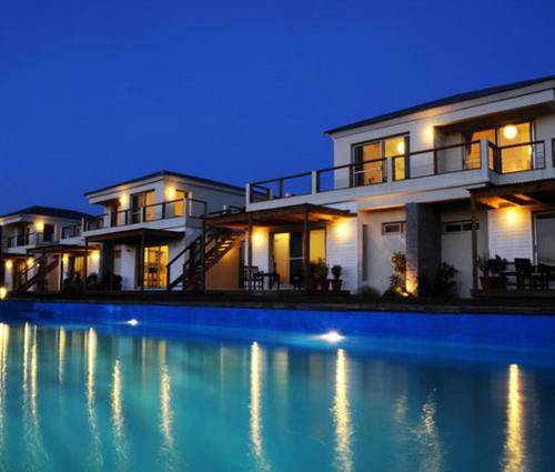 a large swimming pool in front of a house at Las Eduardas in La Paloma