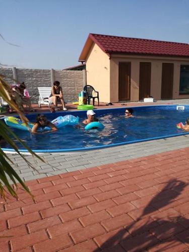a group of people swimming in a swimming pool at Vila Mária Rapovce in Rapovce
