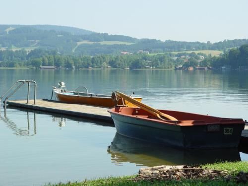 two boats are docked at a dock on a lake at Seehotel Garni Pöllmann in Mondsee