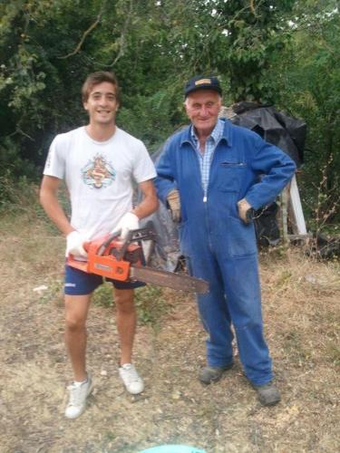 a man standing next to a man holding a chainsaw at Hotel Villa San Donino in Città di Castello