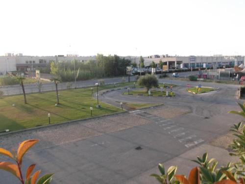 an empty parking lot with a park in the background at Hotel Bed&Business in San Giovanni Teatino