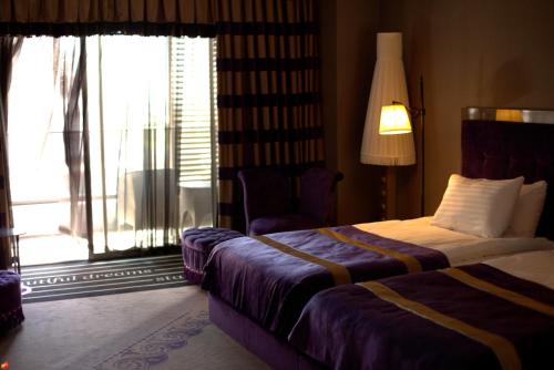 a hotel room with two beds and a window at Selectum Luxury Resort Belek in Belek