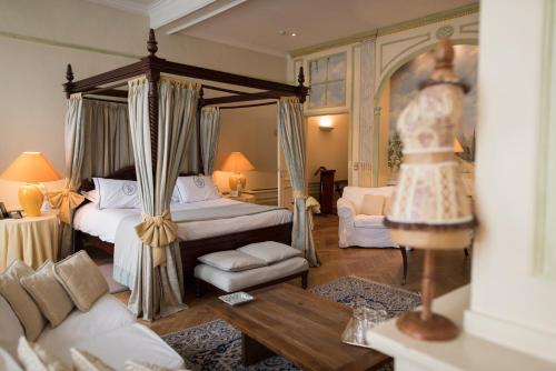 sypialnia z łóżkiem z baldachimem i salon w obiekcie Hotel Le Dixseptième w Brukseli