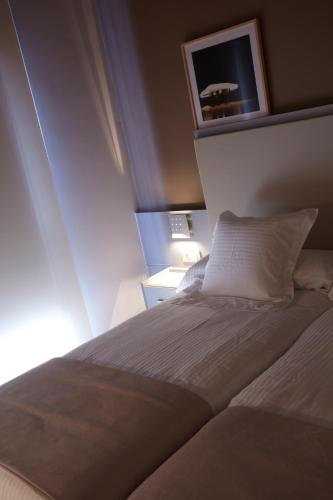 Ένα ή περισσότερα κρεβάτια σε δωμάτιο στο Hotel Nagusi