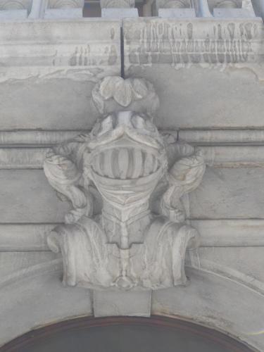a stone building with a vase on the side of it at Palazzo Brigido in Trieste